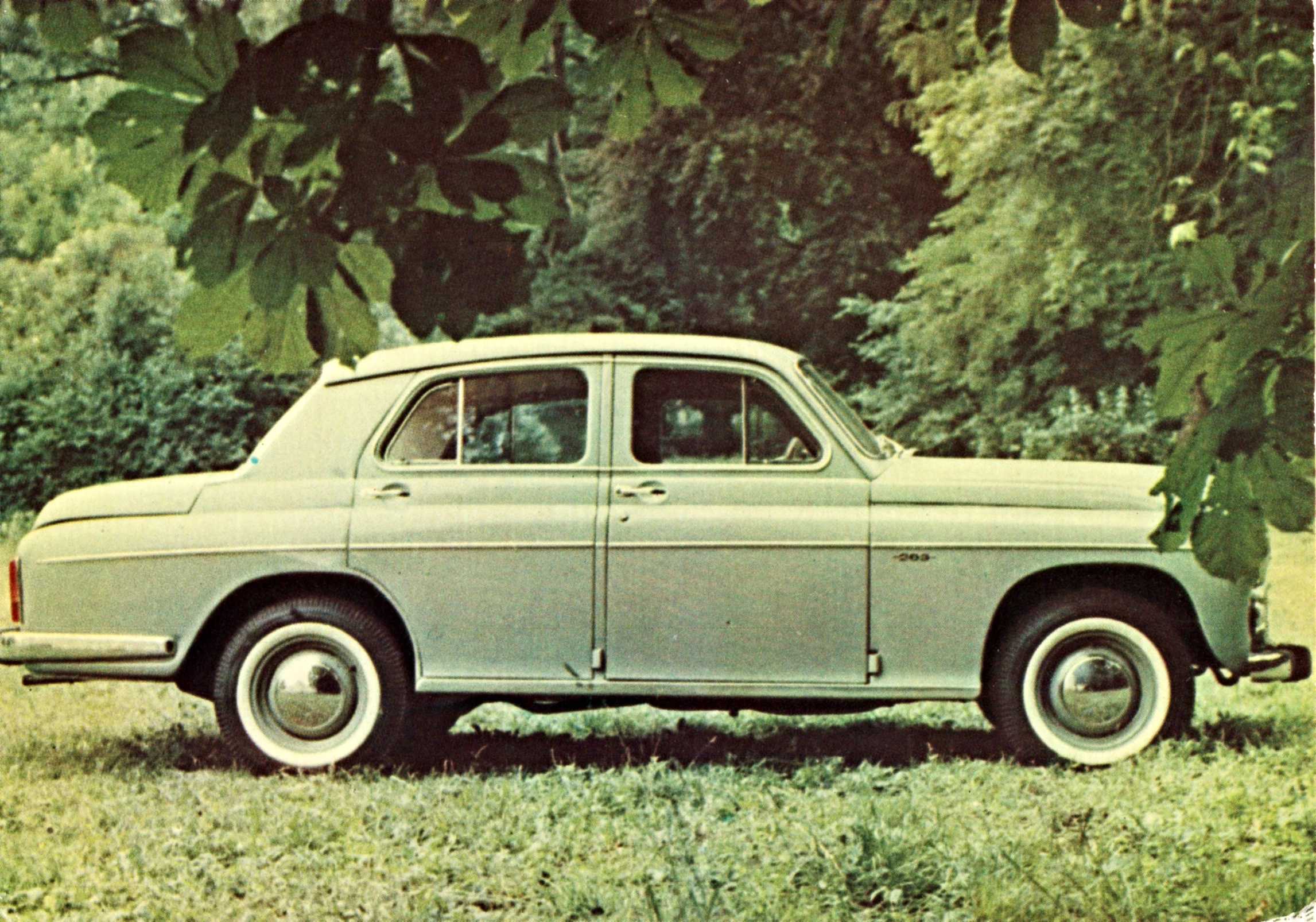 old fashion car parked in a field near trees