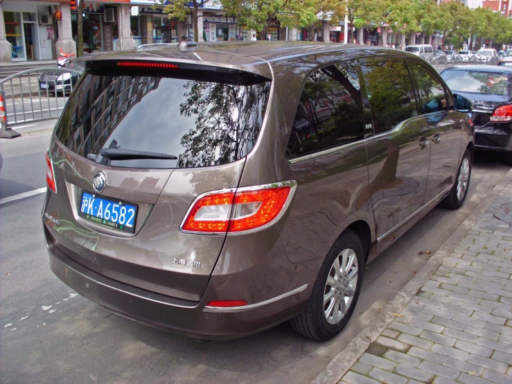 a car parked on the side of a street with lots of cars nearby