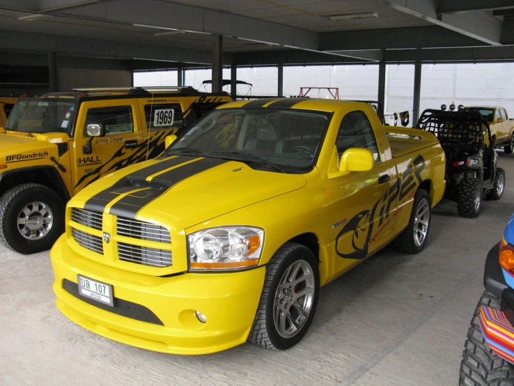 two trucks are sitting side by side in a garage