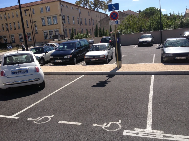 cars and bikes are parked in a car parking space