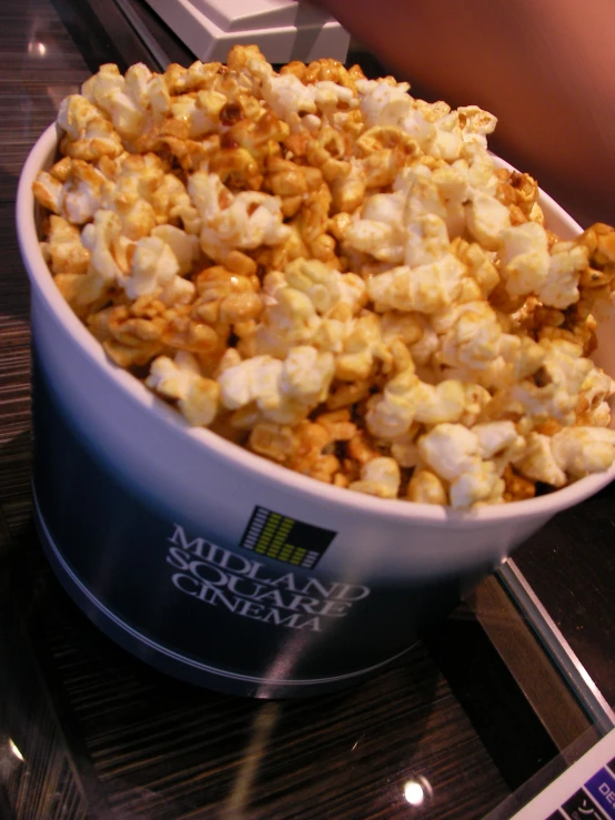 a bowl full of popcorn sitting on top of a table