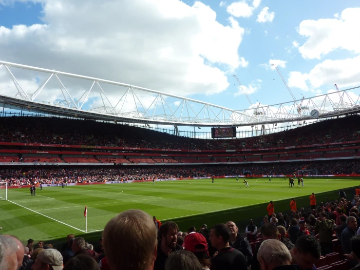 a stadium is full of people playing soccer