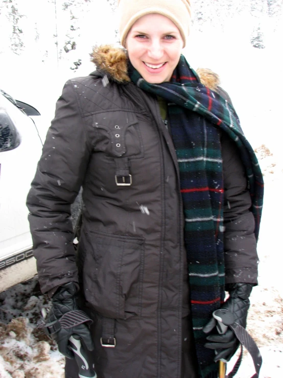 a person standing in front of snow covered mountains