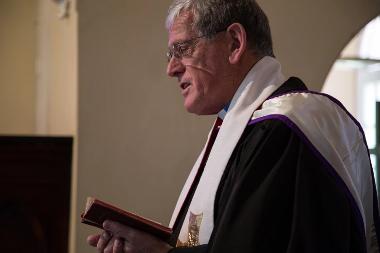 a man in a priest's robes holding a book