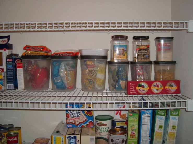 various containers and food items are on a white shelf