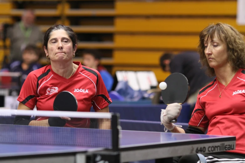 two woman that are sitting on a table