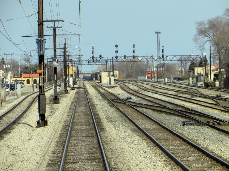 a couple of sets of train tracks with power lines above them