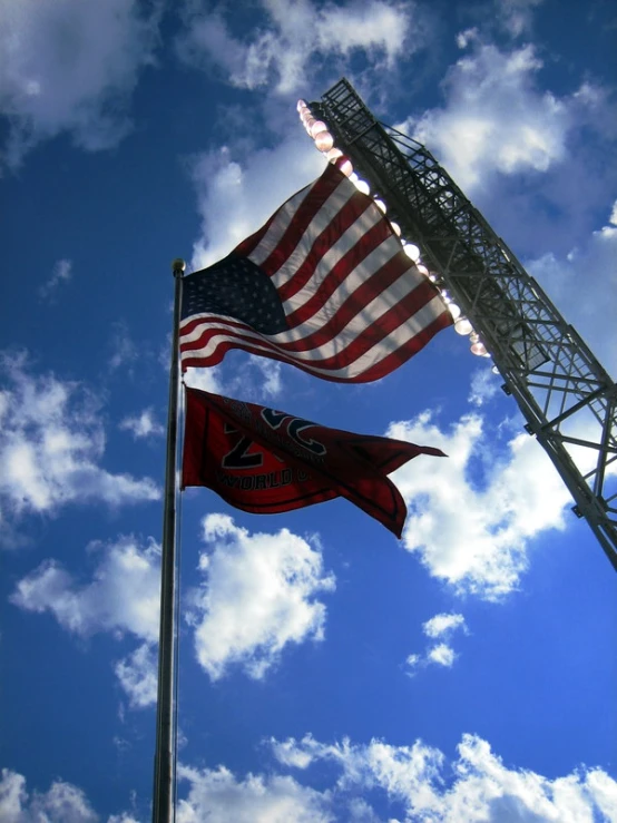 two american flags flying above an outdoor fire hydrant