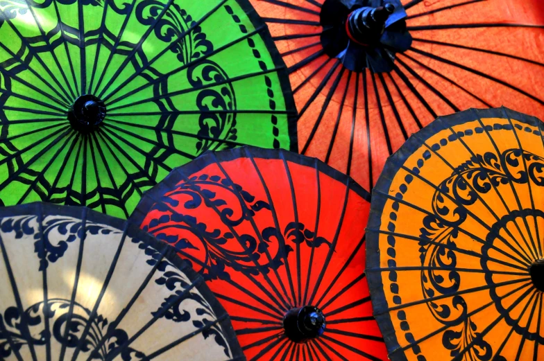 a collection of colorful, elaborate chinese style umbrellas