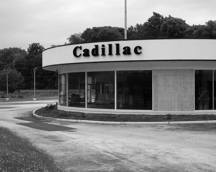 a black and white po of a cadillac dealer