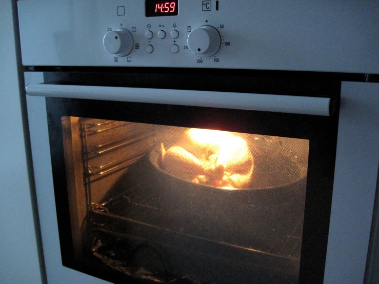 a close up of an oven door with a glowing light coming from the top