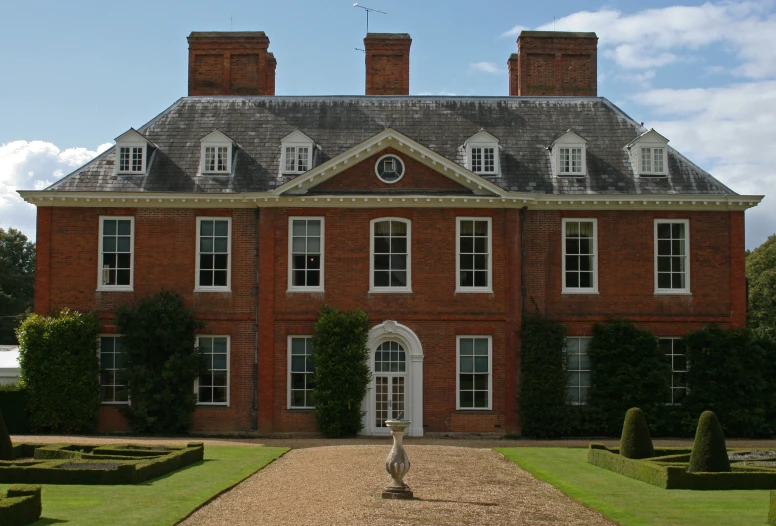 a large brick house with ivy on the roof