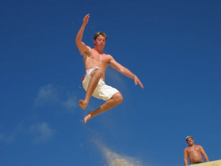 a man flying through the air while jumping a skateboard