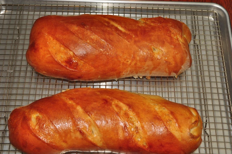 two baked pastries sit on a cooling rack