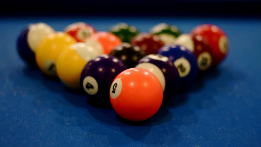 billiards balls are stacked in a row