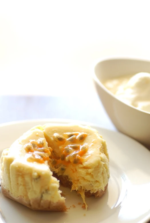 a plate with an open biscuit and a bowl of dressing on it