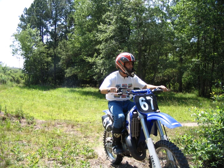 a man riding a dirt bike down a trail