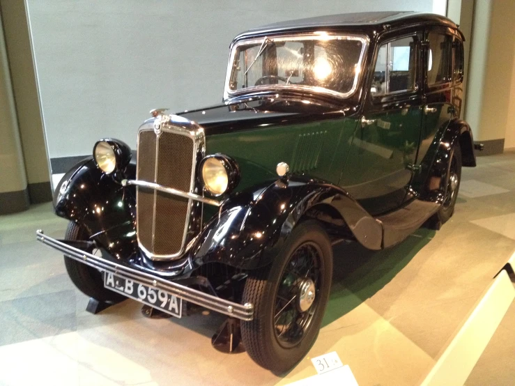 an old - fashioned car on display at the museum