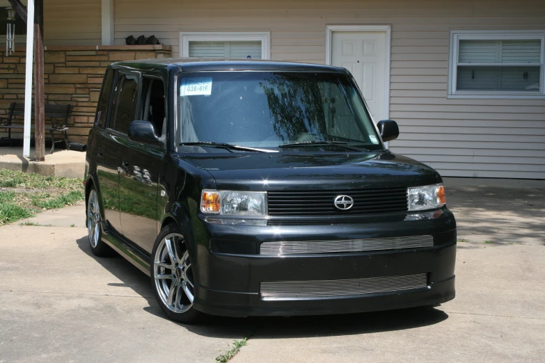 a dark van parked in front of a house