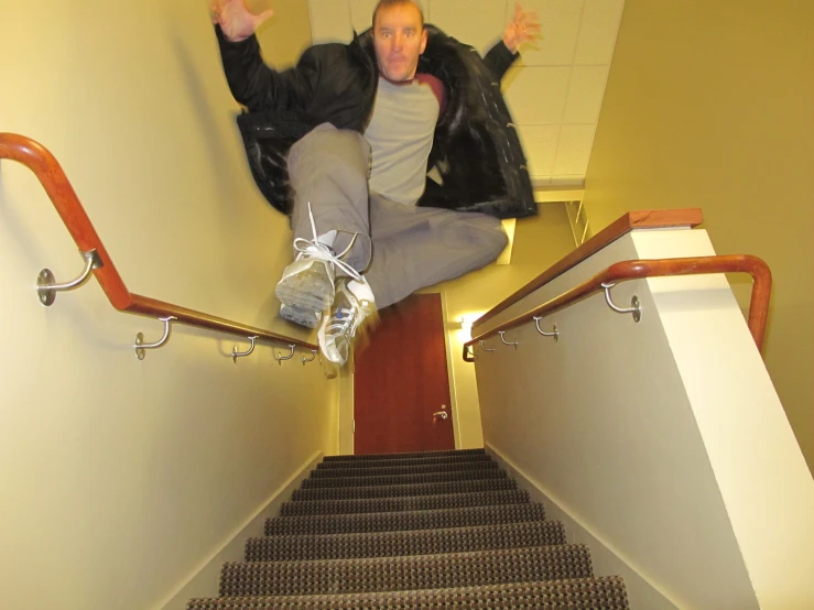 a person who is jumping down stairs with a handrail