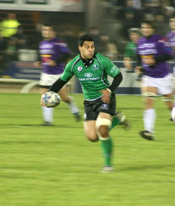 a man running with a soccer ball and holding the ball