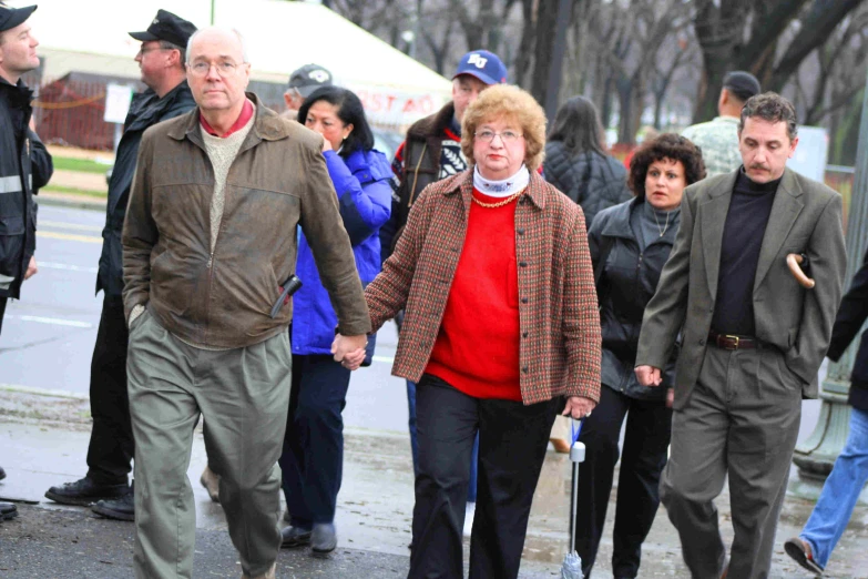 people walking along side the road in the cold