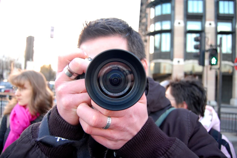 a man taking a picture with a digital camera