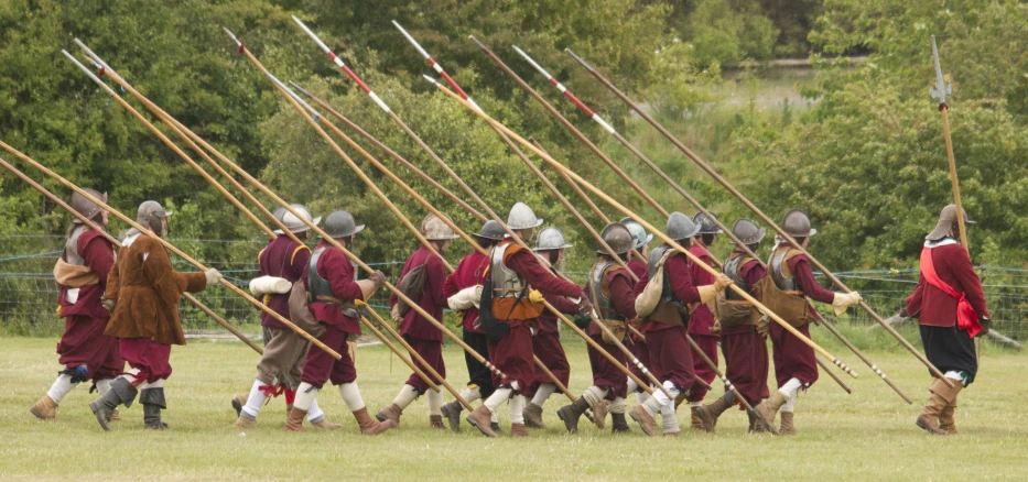 a row of men wearing roman armor holding spears and arrows