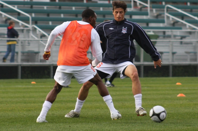 two men playing a game of soccer on a field