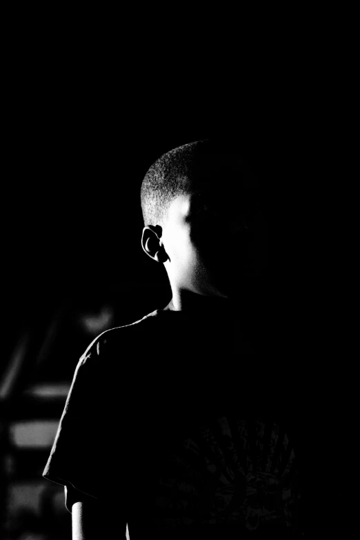 black and white image of boy with shaved hair looking to the side