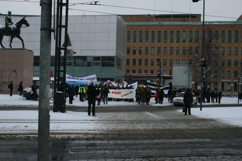 there is a protest in the street near a light pole