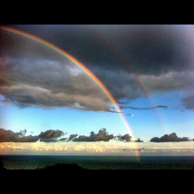 a rainbow and some clouds in the sky