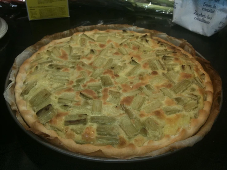 a vegetable pizza sits in an uncooked pan