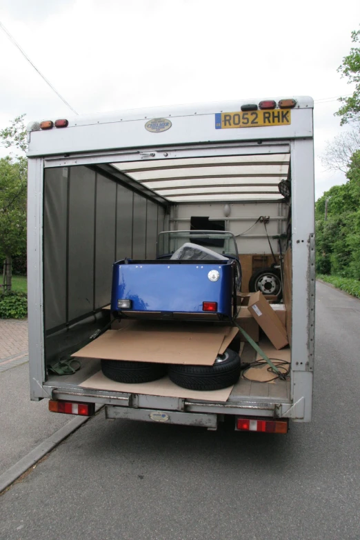 a back of a moving truck is covered in cardboard and furniture