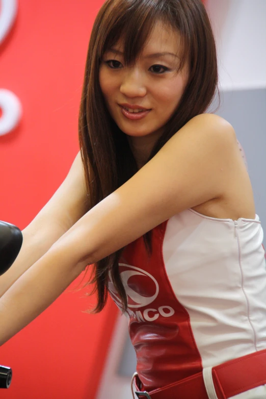 a woman in a white and red dress standing next to a motorcycle