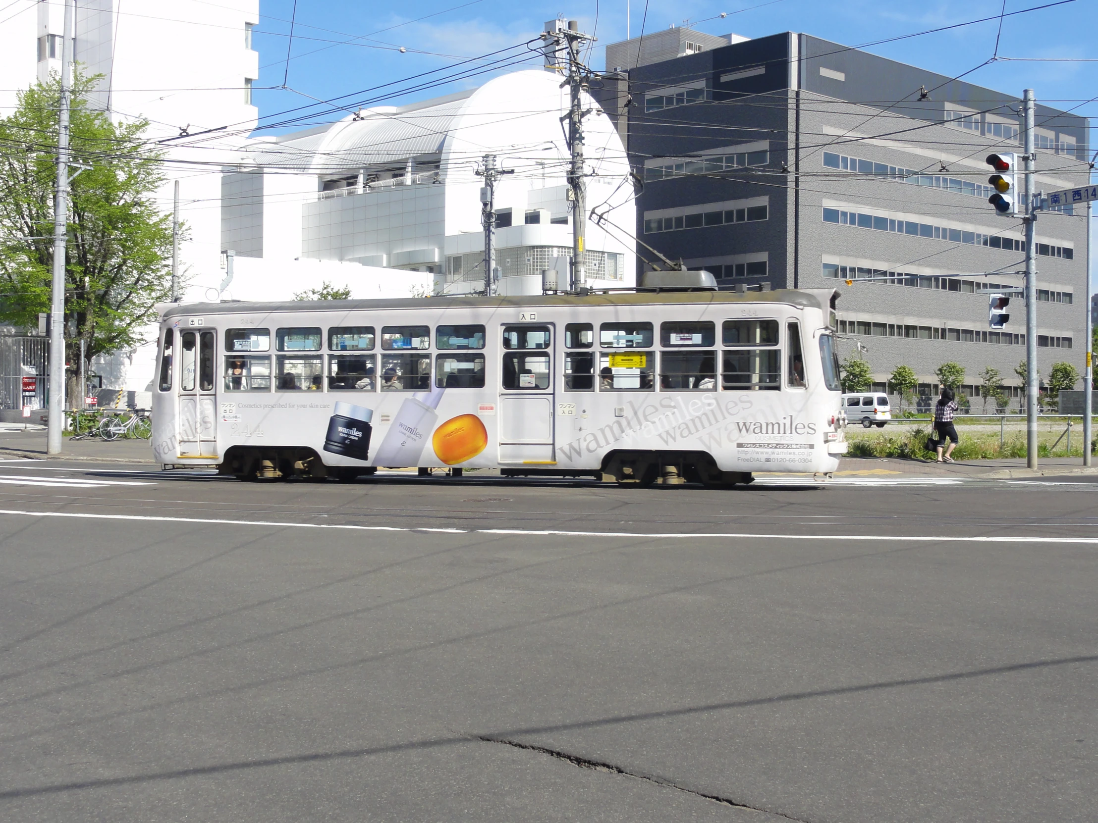 a white and orange bus driving down a street