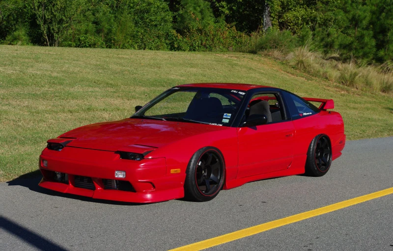 a red sports car parked on the side of a road