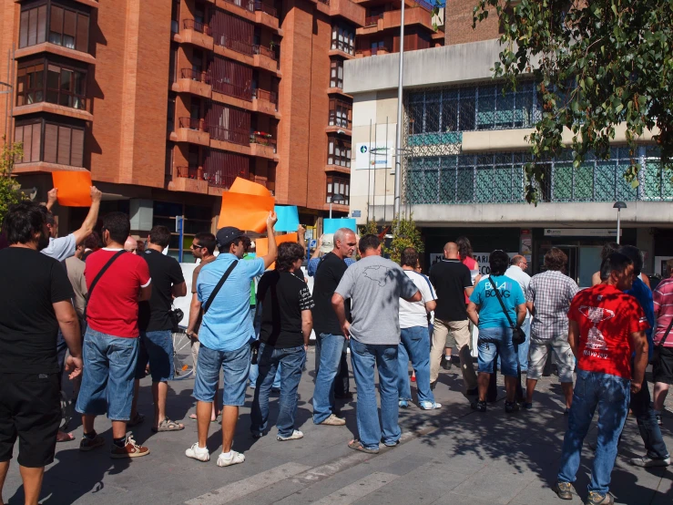 a group of people stand outside of a large building