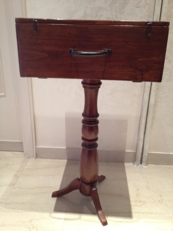 an upright table with a piece of furniture on top of it