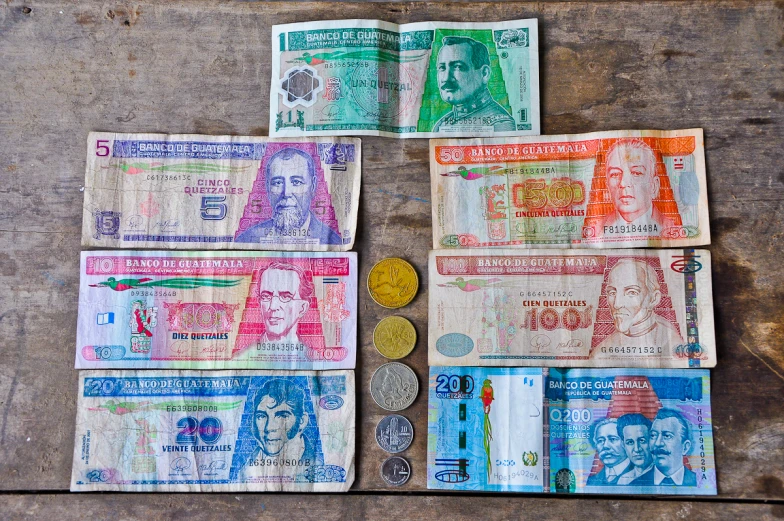 an assortment of money in different styles