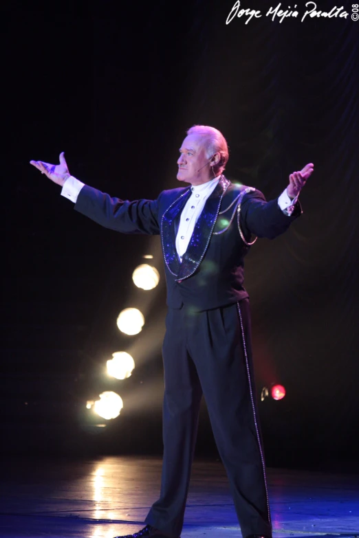 a man in a suit and tie standing on stage