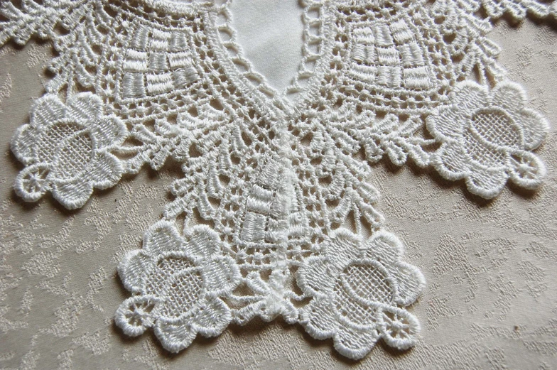 the lacy cloth has white beads attached