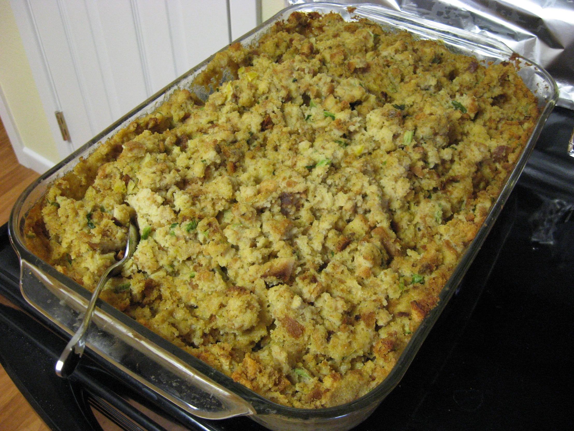 a casserole dish containing chicken stuffing is sitting on the stove