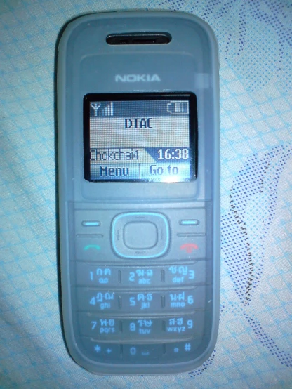 a nokia cell phone on a cloth texture