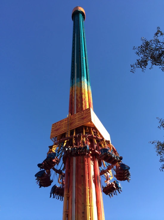 an amut park ride is against the blue sky