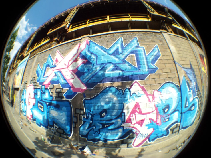 a round panorama picture with blue and white graffiti