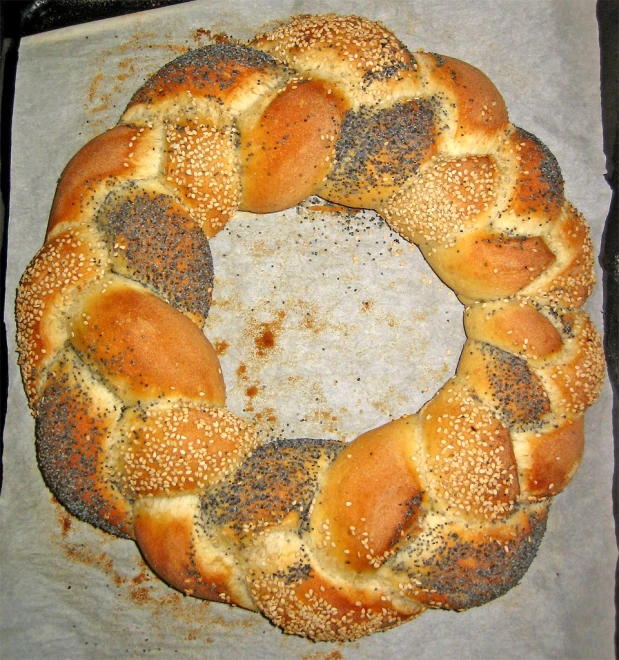 a bagel with seaweed on it sitting on a sheet of parchment