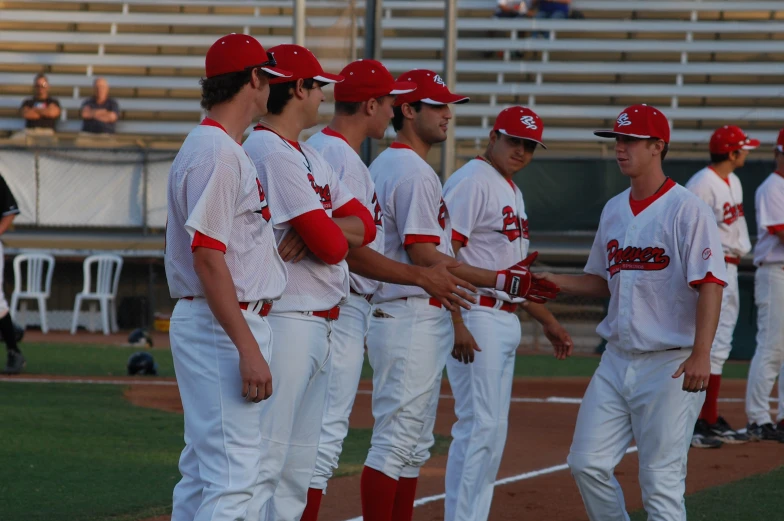 baseball players wearing uniforms with numbers on them standing around