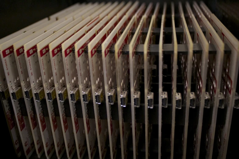 a large stack of white books next to a microwave