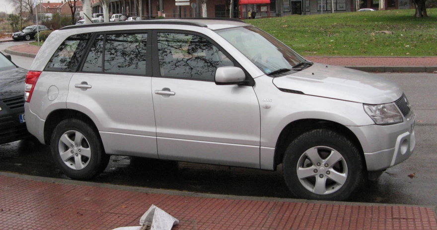 two cars parked on a curb near each other